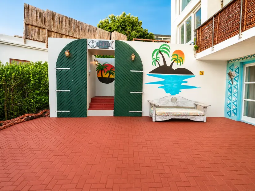 VistaBlu entrance with potted palms and artwork