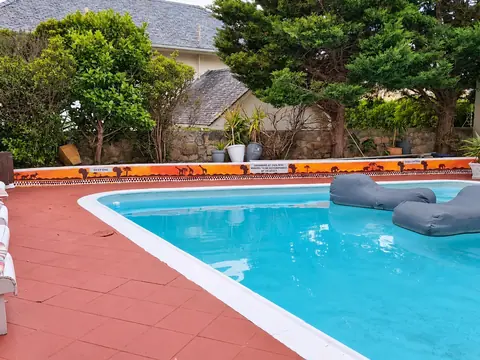 CapeAura garden pool bordered by hand-painted African motifs