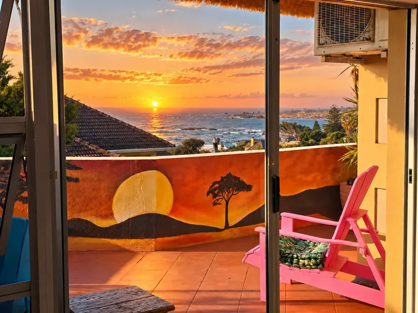 Atlantic sunset viewed from a CapeAura sea-view suite through the doors to its private terrace