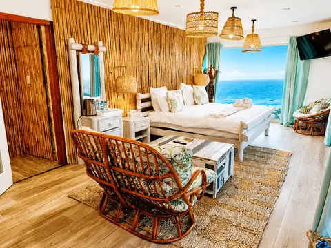 VistaBlu Lion Room with a king bed, sitting area and ocean view